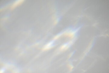 Blurred water texture overlay effect for photo and mockups. Organic drop diagonal shadow and light caustic effect on a white wall. Shadows for natural light effects