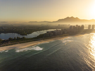 Aerial view of Reserva beach, Marapendi lagoon and car traffic on Lucio Costa avenue. Barra da Tijuca and Recreio, in Rio de Janeiro, Brazil. Sunrise. Sunny day. Drone photo. Praia da Reserva © Diego