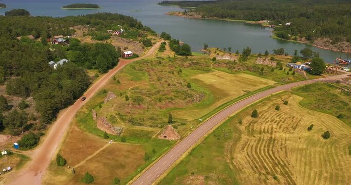 Aerial view away from the Bomarsund castle ruins, in Aland, Finland - rising, pull back, drone shot