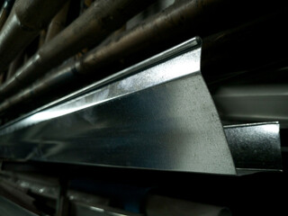 Galvanized steel gutters in Storage Metal Rack with Wall Mount, gutters with blurred background, photo is Depth of Field style
