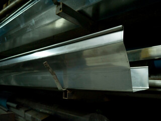 stainless steel gutters in Storage Metal Rack with Wall Mount, gutters with blurred background, photo is Depth of Field style
