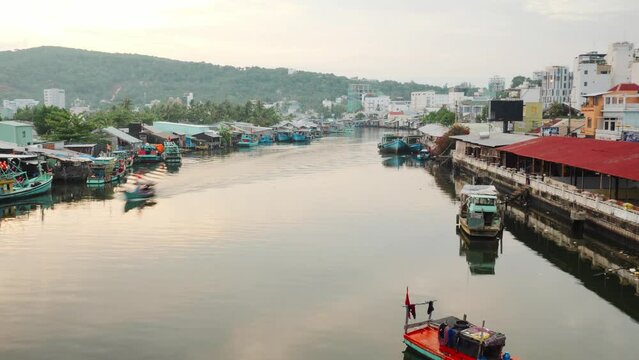 Fishing boats and fisherman houses TIMELAPSE on the water in Vietnam. Timelapse video of Vietnamese traditional fishing boats floating in golden sunset. Hon Son island, Kien Giang, Vietnam.