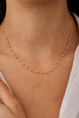 stylish elegant gold necklace on young girl's neck