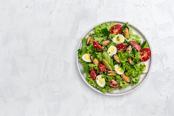 Fresh salad with mussels, quail, egg, conjugate, lime, spinach, lettuce, cherry tomatoes and microgreen. Dietary salad. banner, menu, recipe place for text, top view