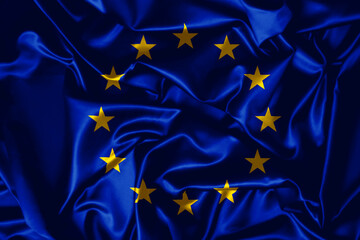 European Union flag waving in the wind. Close up of Europe banner blowing, soft and smooth silk. Cloth fabric texture ensign background. 
