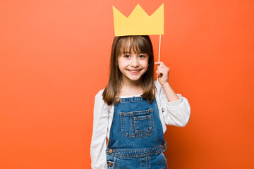 Happy little princess with a paper crown