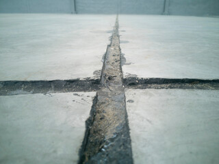 Asphalt in contraction joints, line is dirty, photo is depth of field