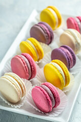 pink macaron or macaroon cakes with peony rose on a white background. Banner, flyer, beautiful postcard, top view