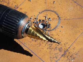 Drill in the shape of a cone for drilling. Step drill bit and power tool. Gradual hole cutter in...
