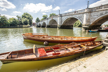 Inside out view of Rowing boats for rent under Richmond bridge at the river Thames, London, United Kingdom.