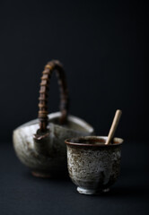 Traditional, handcrafted ceramic on dark background. Soft focus. Close up. Copy space.