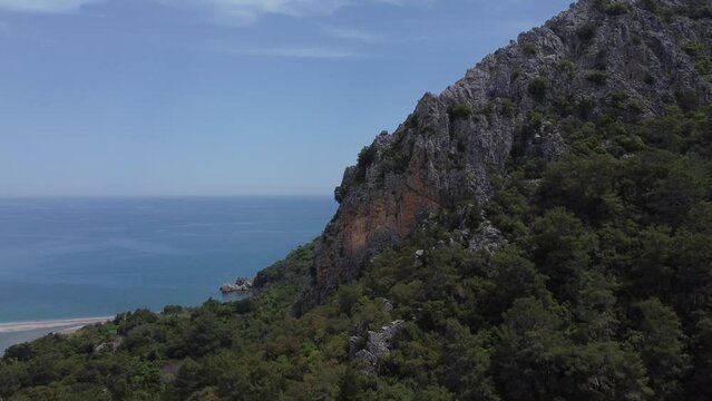 Sunny day, aerial view, flyby of points of interest, Mount Olympus, Olympus village, Turkey, Lycian Trail. Aerial drone of Cirali beach and Olympos Olimpos mountain in a beautiful day light. Kemer