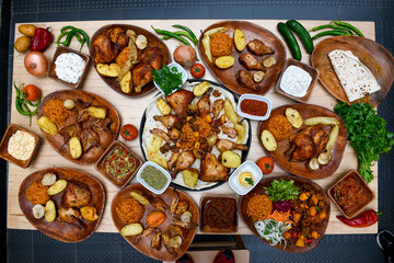 Delicious meat kebab with fresh vegetable salad served with variety of Turkish dishes and appetizers. Top view of assorted Turkish food and meze, tasty and healthy Mediterranean cuisine.