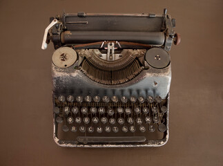 Fototapeta na wymiar Vintage typewriter on an old brown desk. View from above.