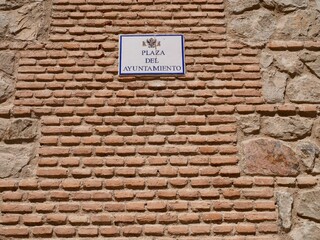 Close up of facade of Archbishop's Palace, Palacio Arzobispal in Toledo with sign indicating Plaza del Ayuntamiento. Castile La Mancha, Spain.