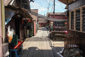 A wooden walkway through traditional stilt houses in the Clan jetties of a waterside village in George Town.