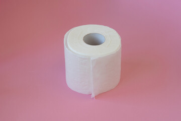 Rolls of white toilet paper on pink background