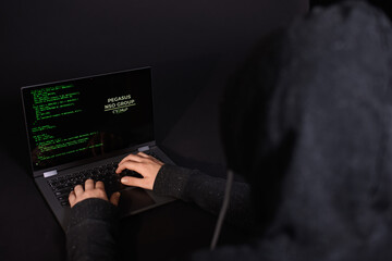 Concept of hacking and malware. Hacker using an abstract laptop with a binary code digital...