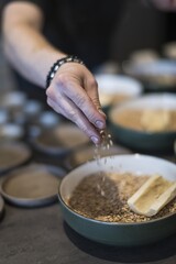 Preparing dinner. Chef's hands, carrot bone, wheat, plate. Slate table, close-up, dining, background, lighting. Beautiful surroundings, adventure restaurant.
