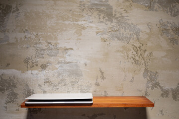 Computer laptop on wooden shelf at wall. Laptop and construction concept