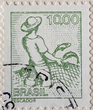 BRAZIL - CIRCA 1977: a postage stamp from BRAZIL, showing a fisherman with hat and net and fish. Circa 1977