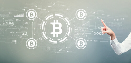 Bitcoin theme with hand pressing a button on a gray background