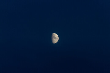 Close up of nice crescent moon on a dark blue sky. Stock photo of the details of the moon in the...