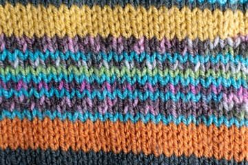 colourful knitting background backdrop with stripes in multi colour and rainbow 
