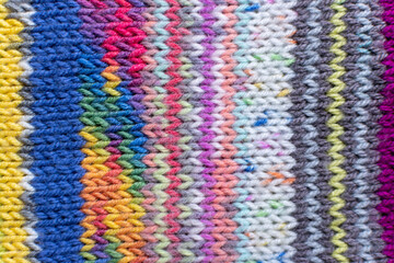 Fototapeta na wymiar colourful knitting background backdrop with stripes in multi colour and rainbow 