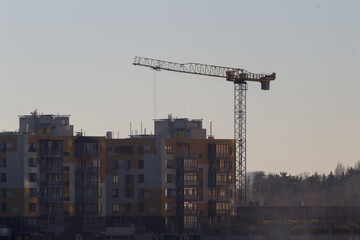 High multi storey residential apartment buildings under construction. Concrete and brick framing of high rise housing. Real estate development in urban area.