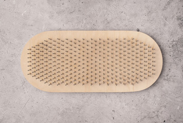 Wooden sadhu board on a light concrete background. Top view, flat lay, space for text. 