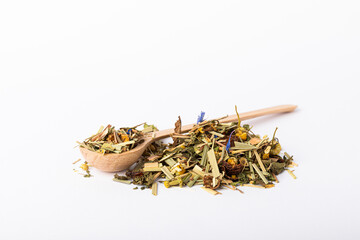 Herbal tea in a slide and in a wooden spoon isolated on a white background. Dry tea leaves in a pile on a white background.