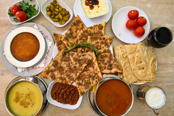 Traditional Turkish cuisine. Pizza, pita, pidesi, sucuk, hummus, kebab. Many dishes on the table. Serving dishes in restaurant. Background image. Top view, flat lay
