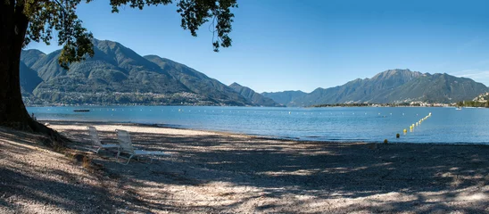 Foto op Plexiglas Lake Locarno - lake shore with pebble beach and high mountains of swiss alps in the background. © Jan