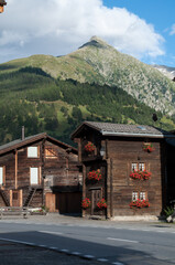 Fototapeta na wymiar Wooden houses in Switzerland below Nufenenpass