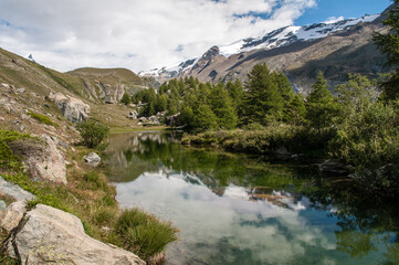 Naklejka na ściany i meble Alpine peaks and beautiful lake in Switzerland