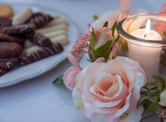 table decoration with biscuit candle and artificial rose