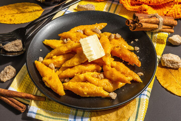 Lazy pumpkin dumplings, gnocchi with butter and brown sugar. Warm autumn dish, sweet healthy food