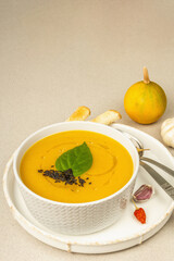 Pumpkin cream soup. Traditional autumn food. Hot dish, ripe vegetables, fragrant spices