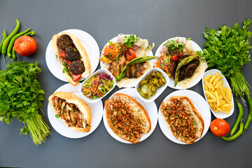 Table scene of assorted take out or delivery foods. Pizza, hamburgers, Doner, fried chicken and sides. Top down view on a table.