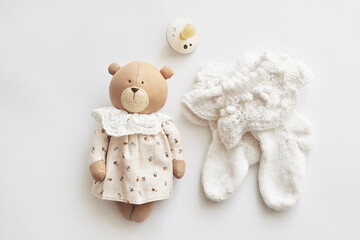 Baby accessories, booties, socks, wooden teether, pacifier, toy. Gift for child.