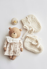 Baby accessories, booties, socks, wooden teether, pacifier, toy. Gift for child.