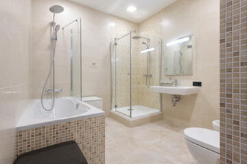 large bathroom with bath and shower in beige tiles, modern bathroom