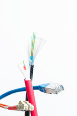 Cut fiber optic cable with fiber optic connectors and a RJ45 patch cord on a white background