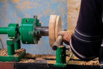 Closeup of carpenter turning wood on a lathe