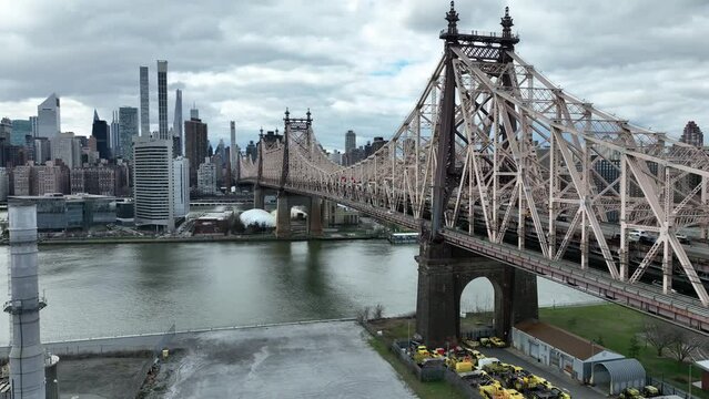 aerial close Queensboro Bridge over East River water toward Manhattan New York City
