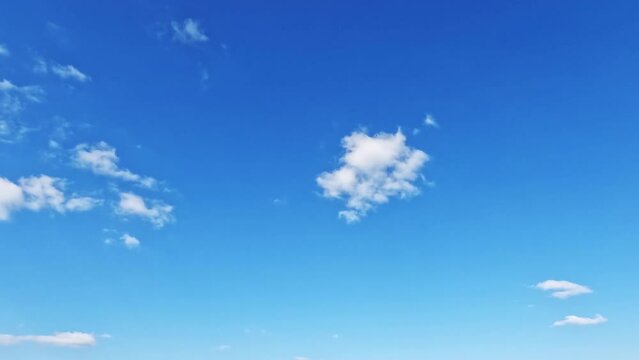 Small clouds float across the blue sky.