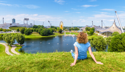 Naklejka premium Girl rests in Olympic Park in summer, Munich, Germany, Europe