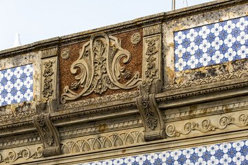 Close view of a traditional decorated front wall in the village of Fuseta, Algarve, Portugal