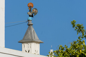 Fototapeta na wymiar traditional openwork chimney on a roof in Fuseta, Algarve, Portugal..